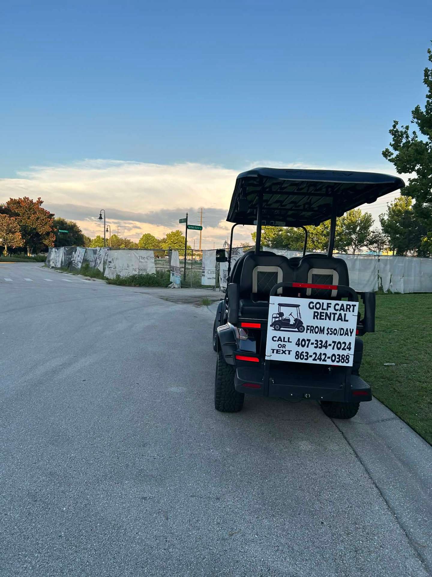 Green ICON golf cart rental with $50/day rental sign